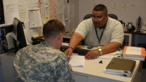 William Kyle, Physical Evaluation Board Liaison Officer, Medical Evaluation Board Clinic, Carl R. Darnall Army Medical Center, Fort Hood, Texas, explains the PEBLO process to a Soldier.