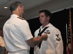 Hospital Corpsman 2nd Class (FMF) Jake Emmott receives the Silver Star from Vice Chief of Naval Operations Adm. Jon Greenert during the third annual Safe Harbor awards ceremony July 14, 2011